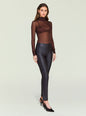 Side view of a model wearing Cyra Leather Legging with a brown sheer top. thumbnail image 2 of 5