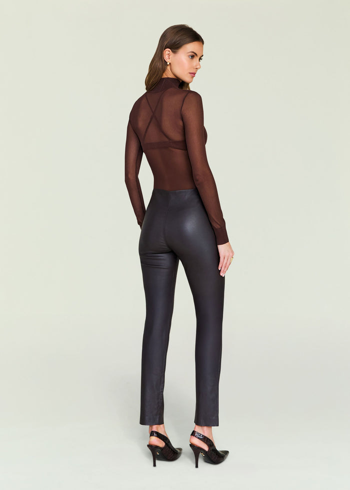 Back view of glossy black Cyra Leather Leggings on a model.