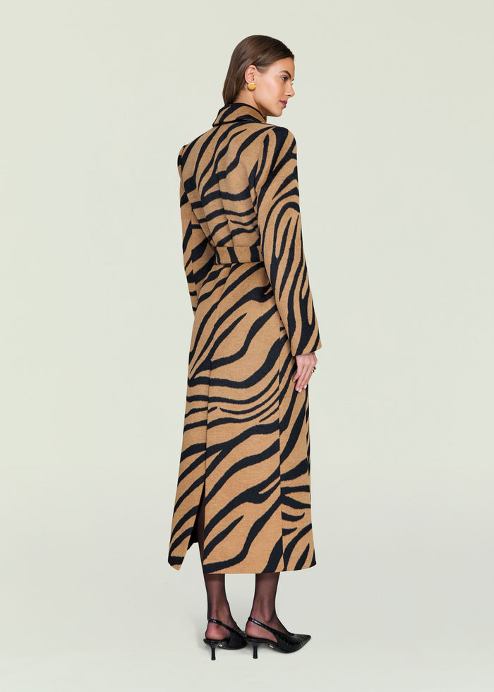 Back view of a model wearing the Petal Coat in camel tiger stripe with a waist belt