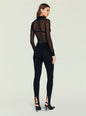 Back view of a model in a sheer black top under a double breasted blazer with high waisted stirrup leggings thumbnail image 4 of 5