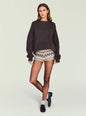 Model wearing a dark brown chunky knit sweater paired with beige and brown patterned knit shorts thumbnail image 5 of 5