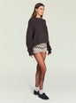 Model wearing a dark brown chunky knit sweater paired with beige and brown patterned Orly Knit Short. thumbnail image 3 of 5