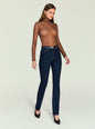 Front view of a woman wearing a brown sheer knit turtleneck Piper Top with dark jeans and belt. thumbnail image 5 of 5