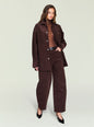 Woman wearing brown corduroy shacket with front pockets and silver buttons over a brown turtleneck. thumbnail image 5 of 5
