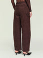 Back view of a model in burgundy corduroy pants with belt loops and large back pockets. thumbnail image 4 of 5