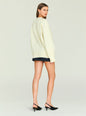 Back view of cream Alejandra Sweater on a model with a loose fit and ribbed hem. thumbnail image 4 of 5