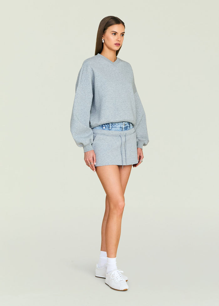Light gray Taley Sweatshirt with matching shorts on a model against a pale backdrop