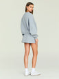 Side profile of a model wearing an oversized light gray Taley Sweatshirt thumbnail image 4 of 5