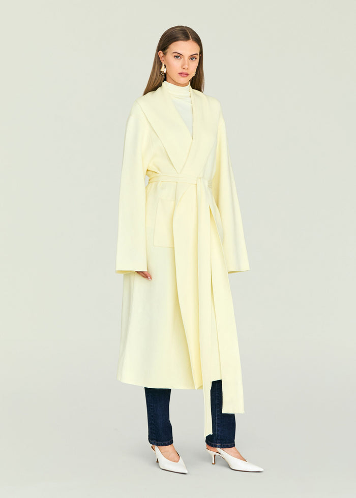 Crosby Sweater Duster pale yellow long belted coat worn by a model facing forward