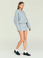 Three-quarter profile of a model in a heather gray Dionne Mini Dress with oversized sleeves and a drop waist thumbnail image 3 of 5