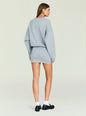 Back view of a model in a light gray Dionne Mini Dress showing loose sleeves and a slim mini skirt thumbnail image 4 of 5