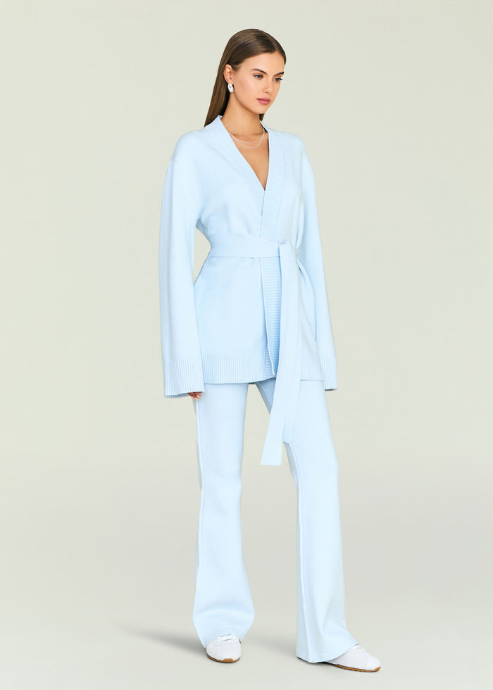 Full body shot of a model in pale blue Katia Knit Pant set with wide leg pants and sneakers.