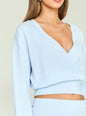 Close up of a model wearing a light blue knit top with a deep V neckline and layered silver necklaces thumbnail image 3 of 5