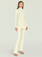 Full length side view of a model wearing a cream Velira Knit Pant with a matching ribbed knit top thumbnail image 2 of 5
