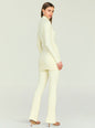 Side view of a model wearing a cream Velira knit top and matching ribbed pants. thumbnail image 4 of 5