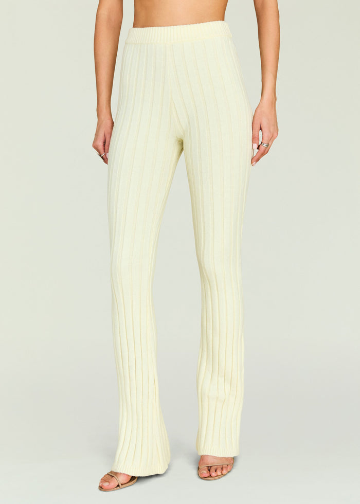 Cream Velira Knit Pant with vertical ribbing and elastic waistband on a model