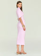 Side view of a model in lavender knit midi dress with a front twist, gold earrings and bracelets, holding a burgundy clutch. thumbnail image 4 of 5