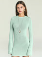 Close up of mint green knit mini dress worn by a model with gold teardrop earrings and necklace thumbnail image 5 of 5