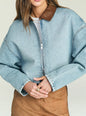 Close up of Coop Denim Jacket in light blue washed denim with brown leather collar and front zipper. thumbnail image 3 of 5