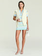 Front view of a model wearing a pastel striped knit tank top with a white knit vest draped over the shoulders. thumbnail image 2 of 5