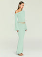Side view of a model wearing a mint-green knit one-shoulder top with a matching skirt. thumbnail image 4 of 5