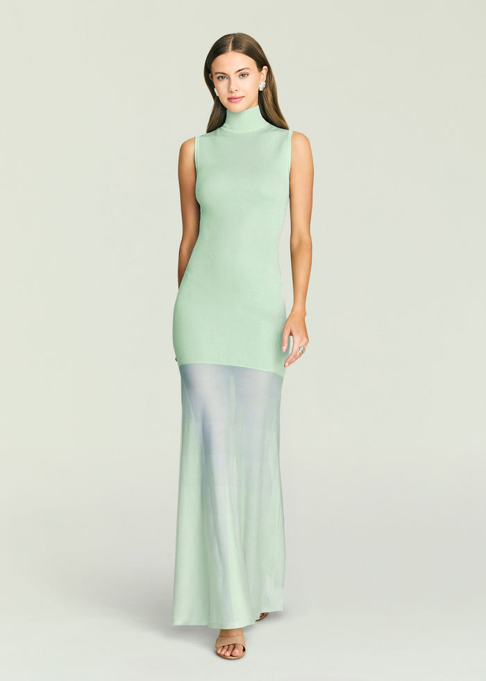 Model in mint Amine knit maxi dress with sleeveless high neck and pale blue sheer overlay at the hem
