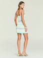 Back view of model in Azriel Knit Mini Dress with pastel stripes and white straps, cardigan draped over shoulders. thumbnail image 4 of 5