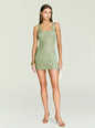 Model wearing Benni Metallic Knit Mini Dress in sage green, full body pose against a pale backdrop. thumbnail image 1 of 5