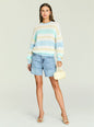Full body shot of a model wearing the Cassian Sweater in pastel stripes with denim shorts and heeled sandals thumbnail image 2 of 5