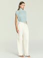 Back view of Giulia Bodysuit in pale blue with draped pleats and a high neck, paired with white pants. thumbnail image 3 of 5