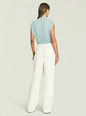 Back view of light blue Giulia bodysuit with pleated draping and a keyhole at the neckline, paired with white trousers. thumbnail image 4 of 5