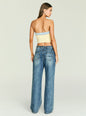 Back view of a model wearing Kiki Knit Top in pale yellow with a light blue denim trim, paired with blue jeans. thumbnail image 5 of 5