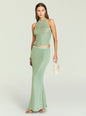 Model wearing a mint green metallic knit two piece set with a halter neck top and matching long skirt, gold hoop earrings. thumbnail image 2 of 5