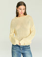 Woman wearing Oro Knit Sweater in soft beige with a loose knit and relaxed silhouette. thumbnail image 1 of 5