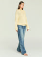 Model in Oro Knit Sweater in pale beige with an oversized fit and relaxed drape, paired with denim jeans. thumbnail image 4 of 5