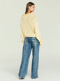 Back view of a cream Oro Knit Sweater with a relaxed fit and ribbed hem, paired with blue denim jeans. thumbnail image 5 of 5