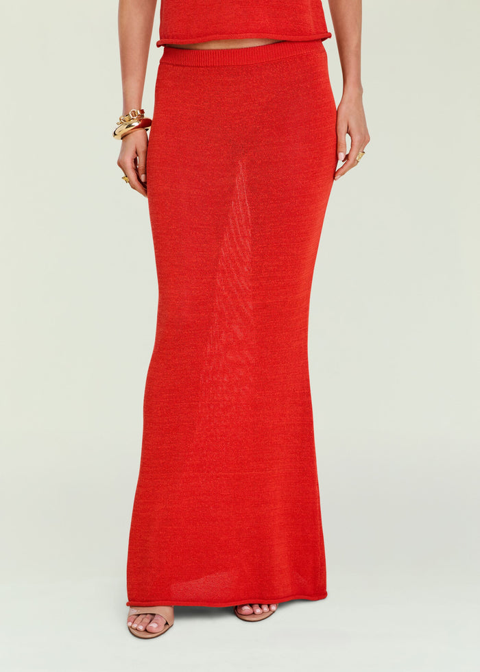 Close up of red knit fabric from the Kora Knit Maxi Skirt showing texture and hem edge