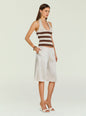 Amira Knit Tank on a model paired with a light neutral skirt, showcasing beige and brown stripes. thumbnail image 4 of 6