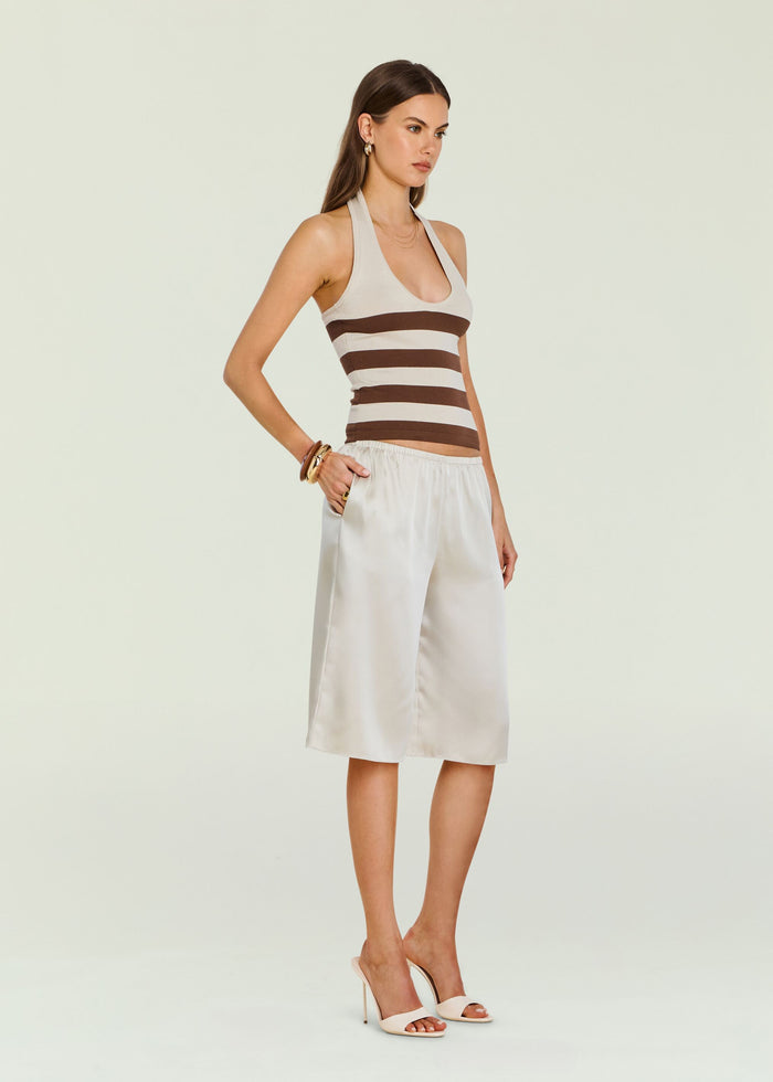 Amira Knit Tank on a model paired with a light neutral skirt, showcasing beige and brown stripes.