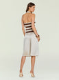 Back view of Amira Knit Tank halter neck sleeveless knit top featuring wide beige and brown stripes and light trousers. thumbnail image 5 of 6