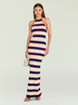 Full length of a model in a red navy white striped knit maxi dress with halter neckline, wearing sandals and carrying a small beige handbag. thumbnail image 1 of 5