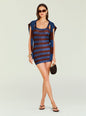 Model in Benni Metallic Knit Dress featuring blue and chocolate striped pattern with a matching draped cardigan and gold accessories. thumbnail image 6 of 6