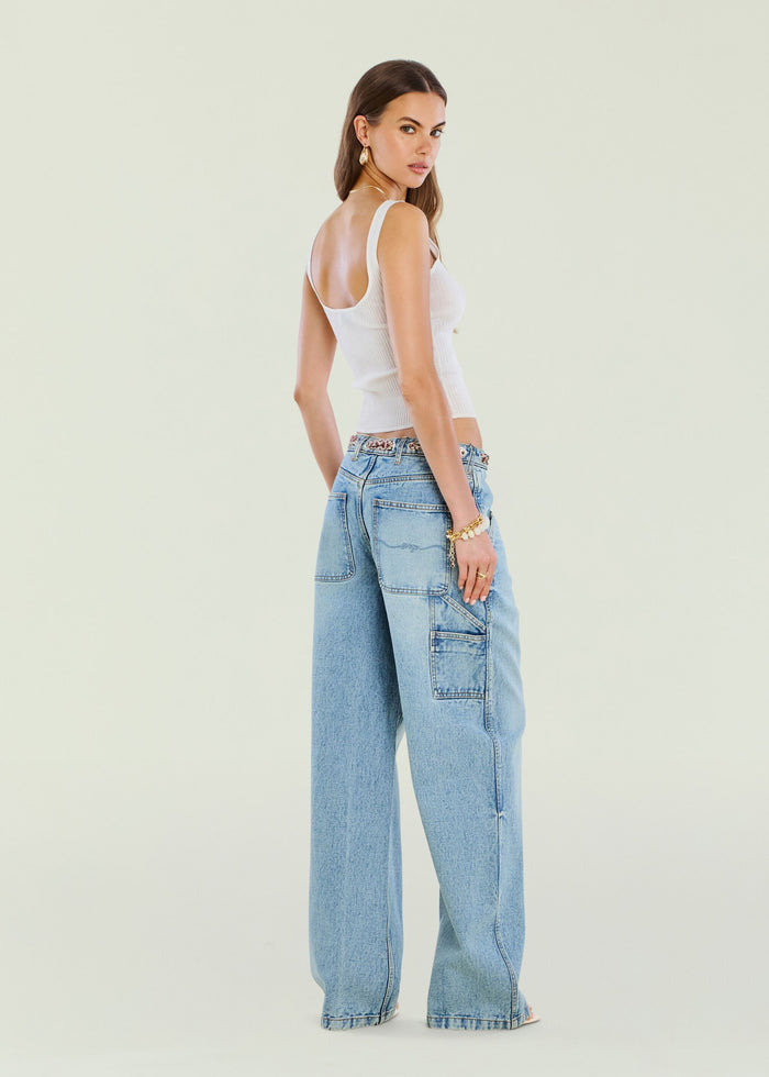 Model in white ribbed tank and light wash Bond Denim Pant shown from the back