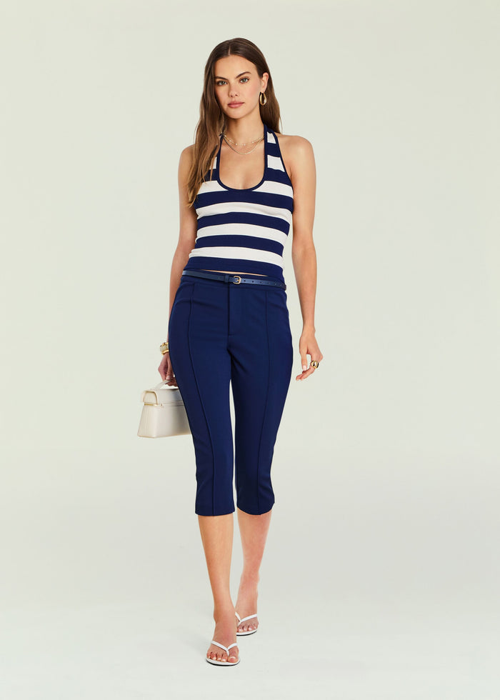 Model wearing navy and white striped Danie Knit Tank paired with navy capri pants and white accessories.