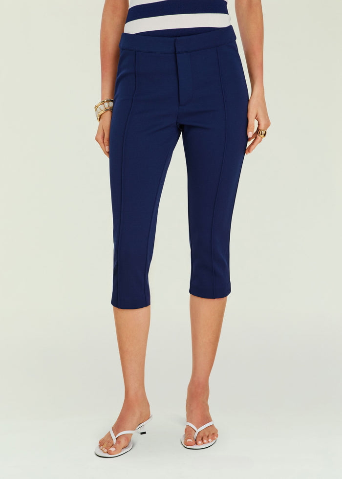 Navy Samra Capri pant worn by a model with a wide waistband and front seam details, cropped to mid calf