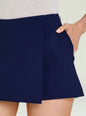 Close-up of navy Deenie Skort showing its waistband and pocket with a model's hand in the pocket thumbnail image 3 of 5