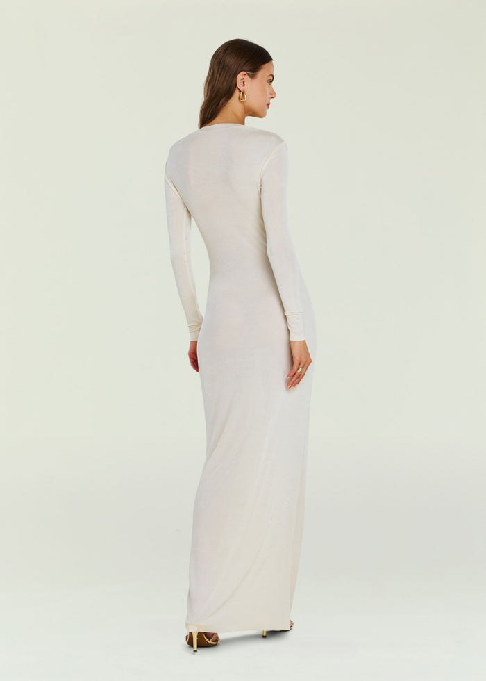 Back view of a model in a cream Ebony Maxi Dress with long sleeves and a floor length silhouette