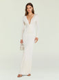 Ebony Maxi Dress worn by a model in ivory with a plunging V neckline long sleeves and ruching at center paired with a small white handbag thumbnail image 1 of 5