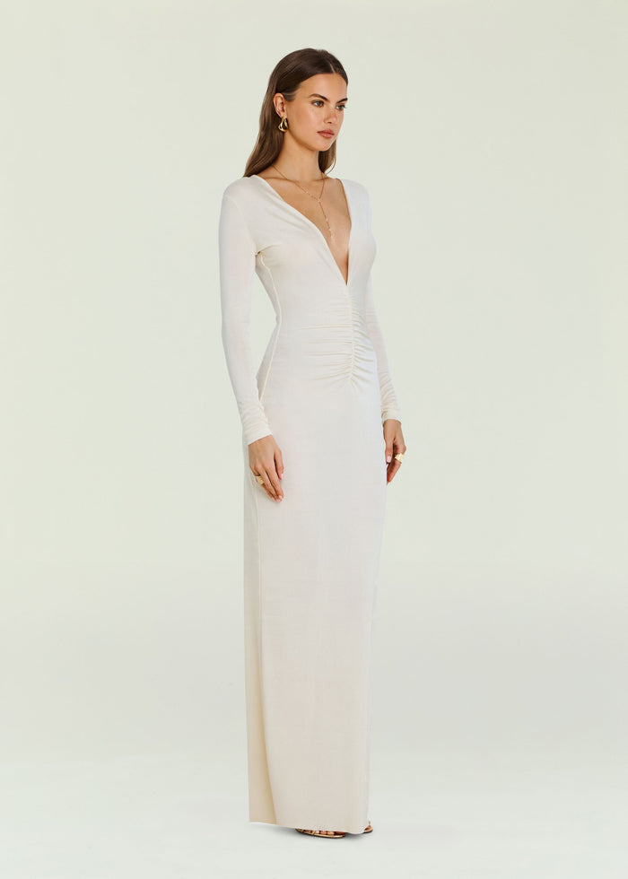 Full length Ivory Ebony Maxi Dress on a model with long sleeves and a deep V neckline wearing sandals