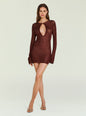Model wearing burgundy Emeri Metallic Knit Mini Dress with a large teardrop chest cutout and long sleeves. thumbnail image 6 of 6